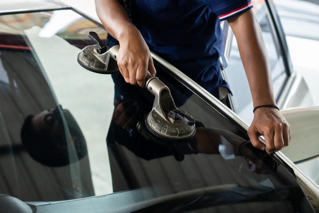 Worker fixing glass of a car