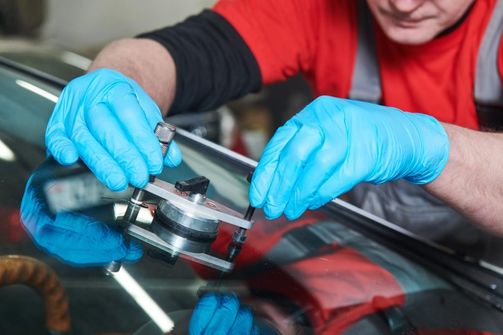 Worker fixing car glass